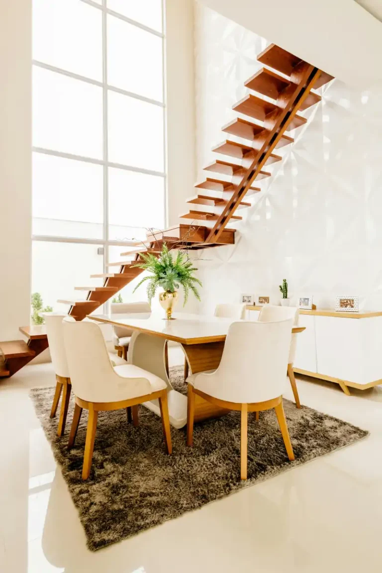 A contemporary dining room featuring a stylish wooden staircase